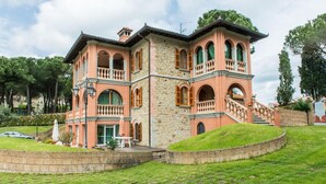 A two-story building with a stone facade, multiple balconies, and a central staircase. - San Bartolomeo LT (Passignano sul Trasimeno)
