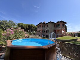 Un edificio grande de dos pisos con una piscina al frente.