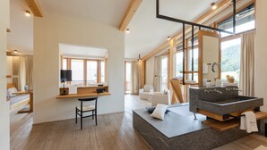 A modern bathroom with a large sink, wooden flooring, and a view of the outdoors. - Posthotel Achenkirch Resort and Spa - Adults Only (Achenkirch)