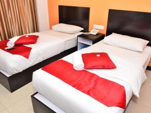 A hotel room with two beds, each with white bedding and red accents. There is a nightstand with a phone and a lamp between the beds. - Hotel O Dspark Port Klang (Pelabuhan Klang)