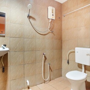 A bathroom with a toilet, a sink, a shower, and a water heater. - 89470 My Town Hotel (Ipoh)