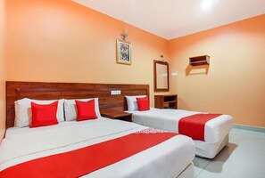 A hotel room with two beds, a wooden headboard, a nightstand, a mirror, and a framed picture on the wall. - 89470 My Town Hotel (Ipoh)