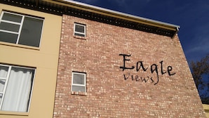 A building with a brick facade and the words "Eagle Views" painted on it. - Eagle Views Windhoek (Windhoek)