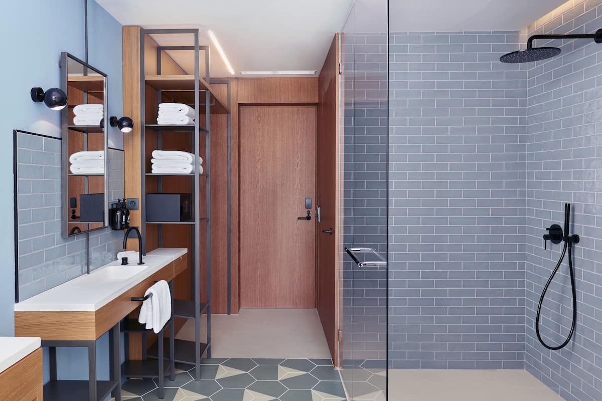 shower, designer toiletries, hair dryer, towels