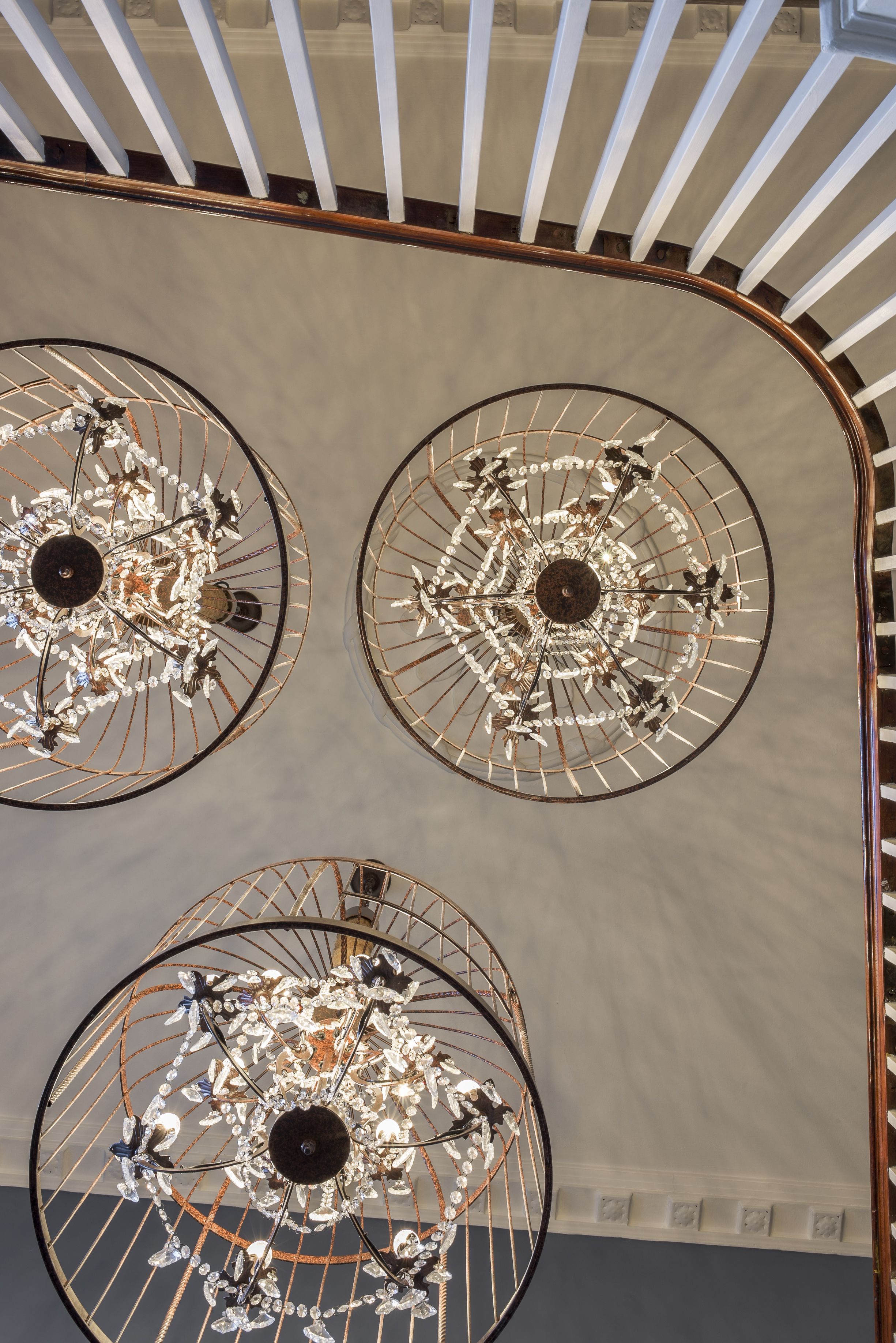 A ceiling with three chandeliers.