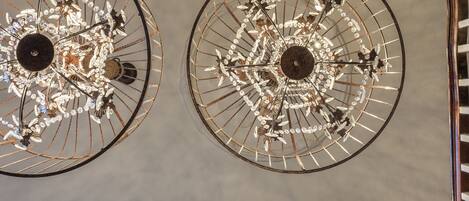 A ceiling with three chandeliers.