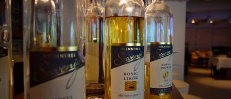 Bottles of Sevensen and Brennerli brand alcohols on a bar counter in a hotel setting.