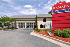 A building with a red sign reading "RAMADA LIMITED" and a smaller sign indicating "AAA Approved".