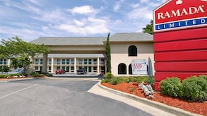 A building with a red sign reading "RAMADA LIMITED" and a smaller sign indicating "AAA Approved". - Days Inn by Wyndham Lexington (Lexington)