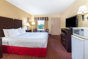 A hotel room with a double bed, a television, a microwave, and a desk with a chair. - Days Inn by Wyndham Lexington (Lexington)