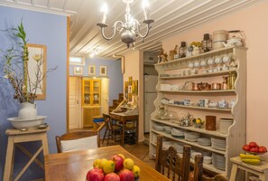 Enjoy meals in this well-appointed dining area with a beautifully set table and a variety of fresh fruits.