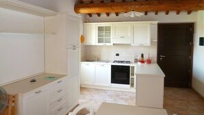A compact kitchen with white cabinets, a gas stove, and a dishwasher. - Villa La Panoramica (late 18th-century mansion) suitable for large groups. (Cingoli)