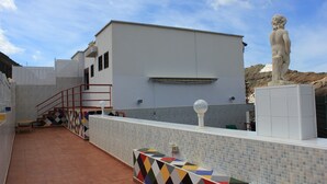 A modern building with a staircase, a statue, and a tiled wall. - A house, a villa, a charm, comfortable interior and wonderful exterior. (Puerto Rico)
