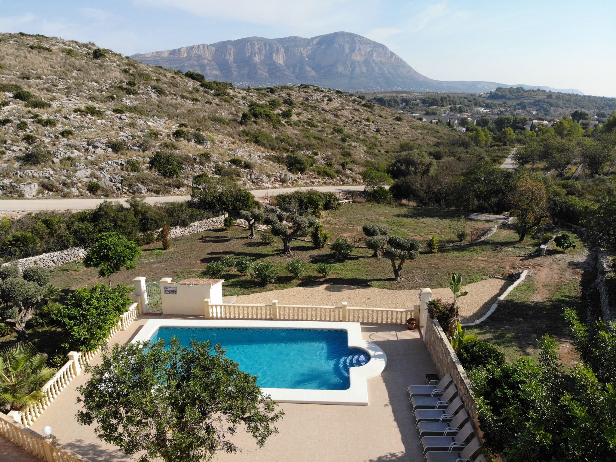 A pool area with a view of a mountainous landscape.
