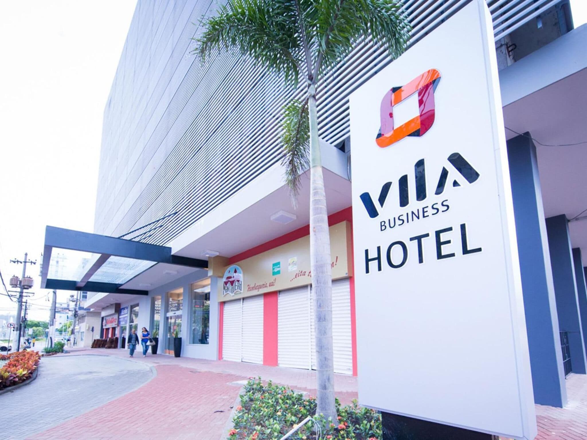 Un bâtiment moderne avec une enseigne indiquant « Vila Business Hotel ».