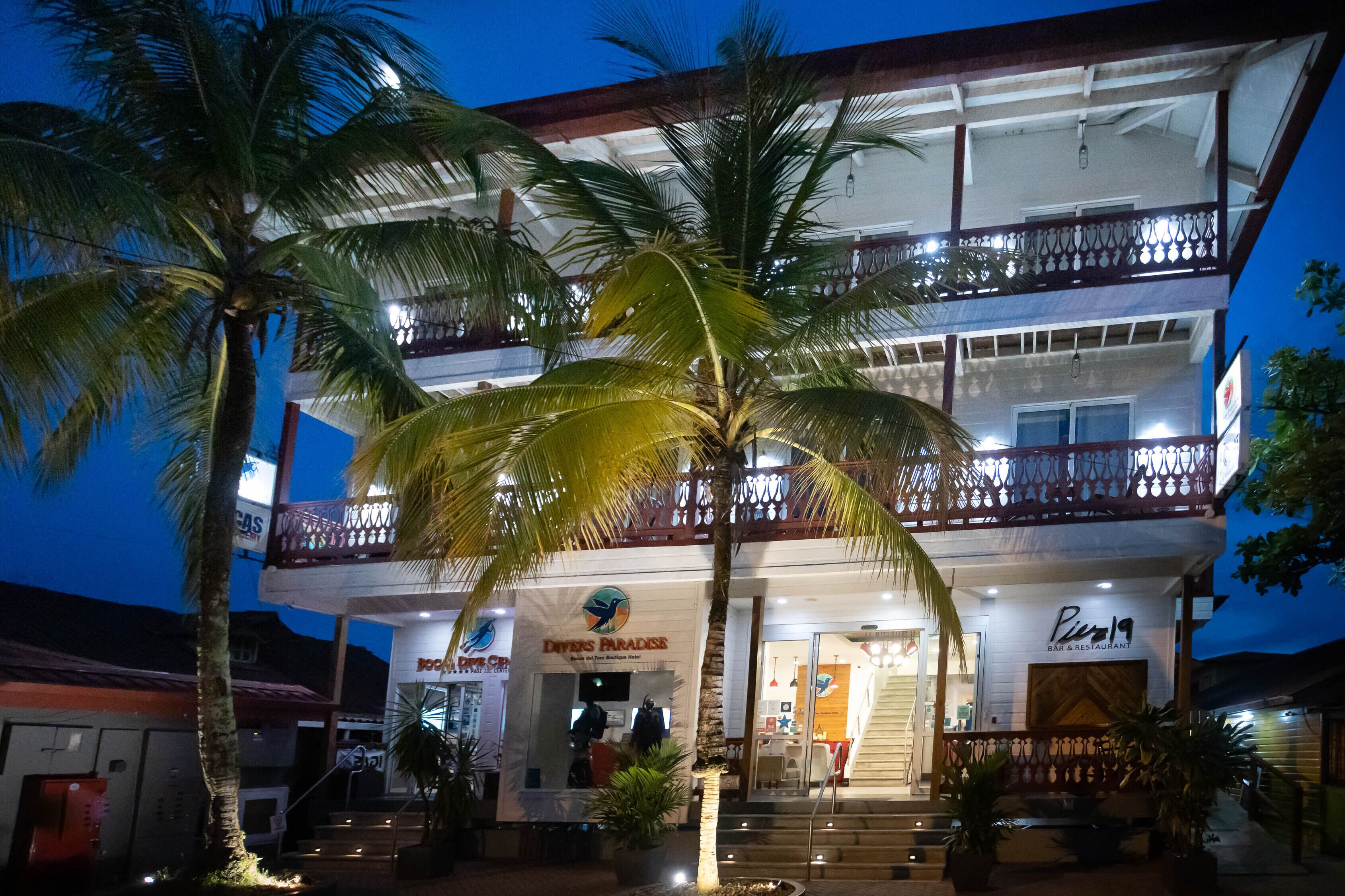 A two-story building with a bar and restaurant named "Dives Paradise" on the ground floor and "Piazza" on the upper floor.