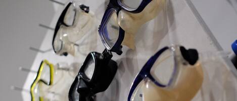 A display of diving masks in various colors.