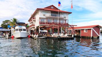 Enjoy waterfront views from the balcony of this property, which offers a restaurant and lounge area with outdoor seating.