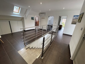 A spacious interior with a staircase, a small skylight, and a door leading to another room. - Villa with large capacity of reception possible departure in the afternoon (Cucq)