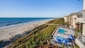 A beachfront hotel with a pool area, beach access, and ocean views. - Villamare 3328, New pools, Ocean views, WiFi, Beachfront, beautifully remodeled. (Hilton Head Island)