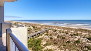 A balcony with a view of a beach and a wooden boardwalk. - Luxury Condominium Next Door to the Ritz Carlton  (Fernandina Beach)