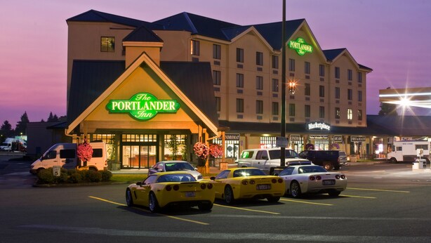 A hotel with a prominent sign reading "The Portland Inn." - Portlander Inn and Marketplace (Portland)