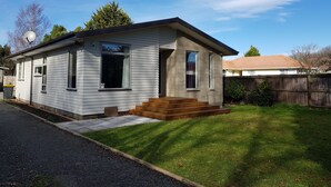 A single-story house with a front porch and a small front yard. - Micro villa (Christchurch)