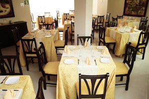 Enjoy a formal dining experience with comfortable seating and elegant table settings.