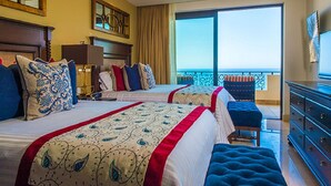 A hotel room with two beds, a balcony, and a view of the ocean. - Presidential Suite at Grand Solmar Lands End Resort. Week 52 available! (Cabo San Lucas)
