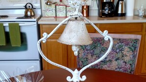 A wooden table with a decorative lamp, a wrapped gift, and a plate of fruit. - The Garden Suite has beautiful views of forests and pastures! It is dog friendly (Ferndale)