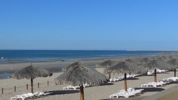 On the beach, sun-loungers, beach towels