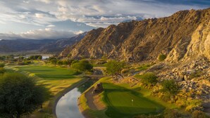 A golf course with a river, trees, and rocky mountains in the background. - Stay Where the Legends Play - Front Row Fairway Views at PGA West Stadium (La Quinta)
