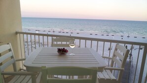 Ein Balkon mit Tisch, Stühlen und einer Obstschale.