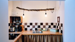 A kitchen with a wooden countertop, a sink, and a hanging light fixture. - Apartment for 2 - 3 people (Wängle)