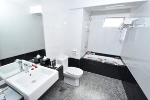 A modern bathroom with a white sink, toilet, and bathtub. - Hotel Tenera (Bandar Baru Bangi)