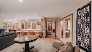 A modern living room with a round dining table, sofas, and a large rug. - 29sl - Hot Tub - Sauna - Bbq - Shuffle Board - Sleeps 11 3 Bedroom Home by RedAwning (Deming)