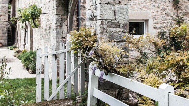 A stone building with a white fence and a small window. - Beautiful, comfortable property set in unspoilt countryside (La Rouquette)