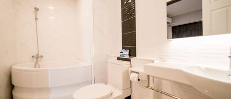 A modern bathroom with a toilet, bidet, and a sink.