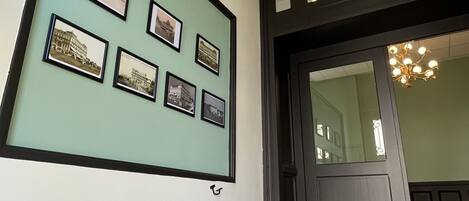 A staircase leading to a room with framed pictures on the wall.