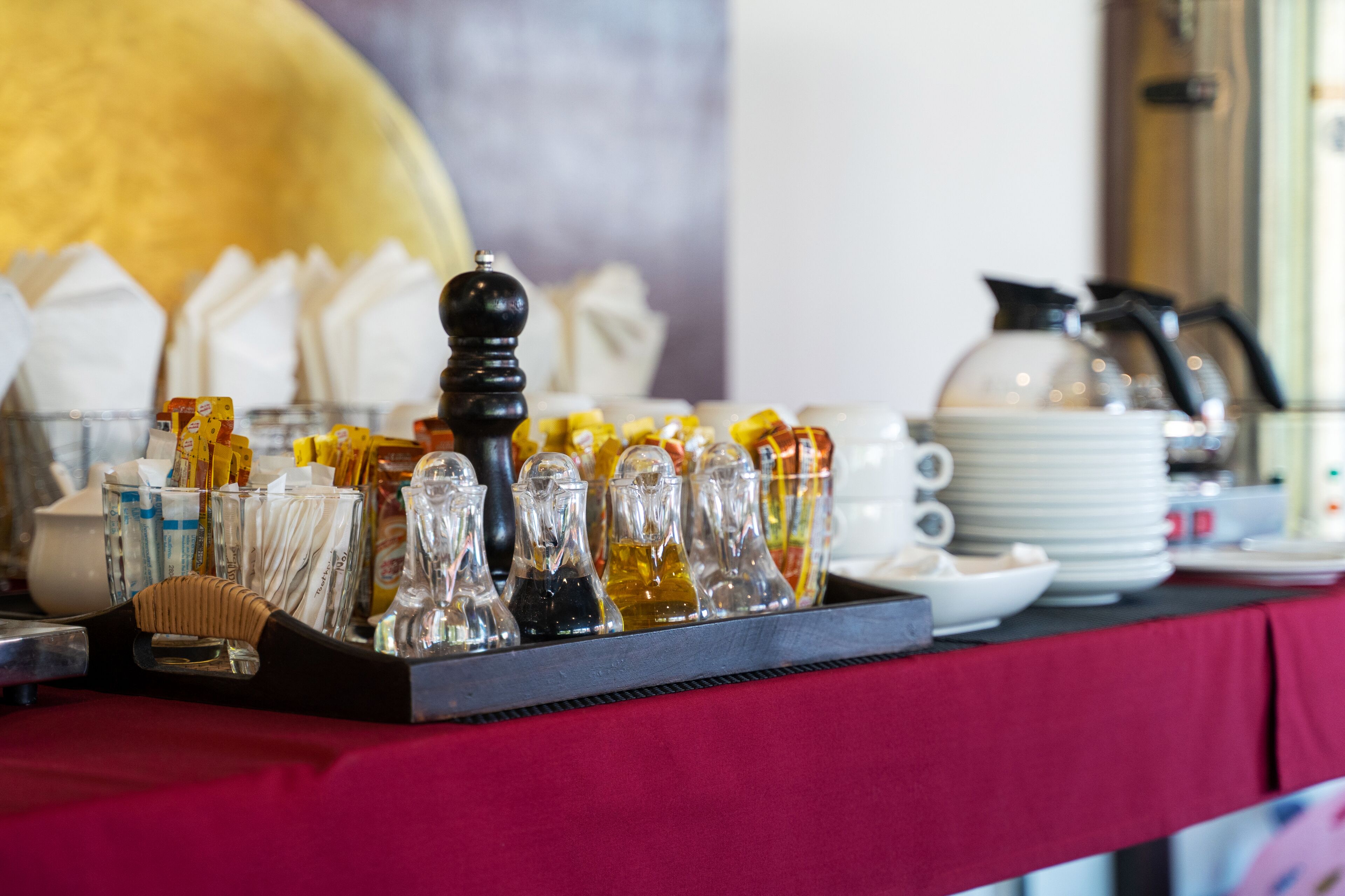 A buffet setup with various food items and condiments on a table.