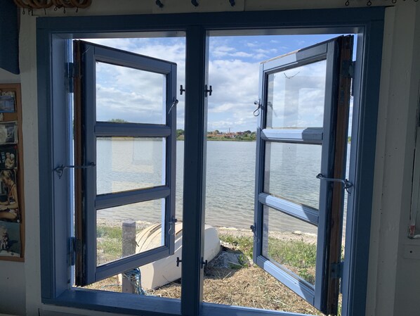 A room with a large window overlooking a body of water.