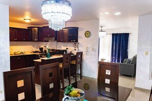 Enjoy meals in the well-equipped kitchen with an oven and sink, and dine at the dining table with comfortable seating.