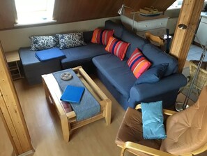 A cozy living area with a sofa, a coffee table, and a chair.