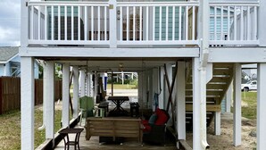 A two-story house with a balcony and a covered porch. - Prime Location 1 Bedroom 1 Bath! (Carolina Beach)