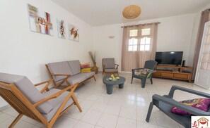 Relax in this stylish living room with a sofa, coffee table, and comfortable armchair.
