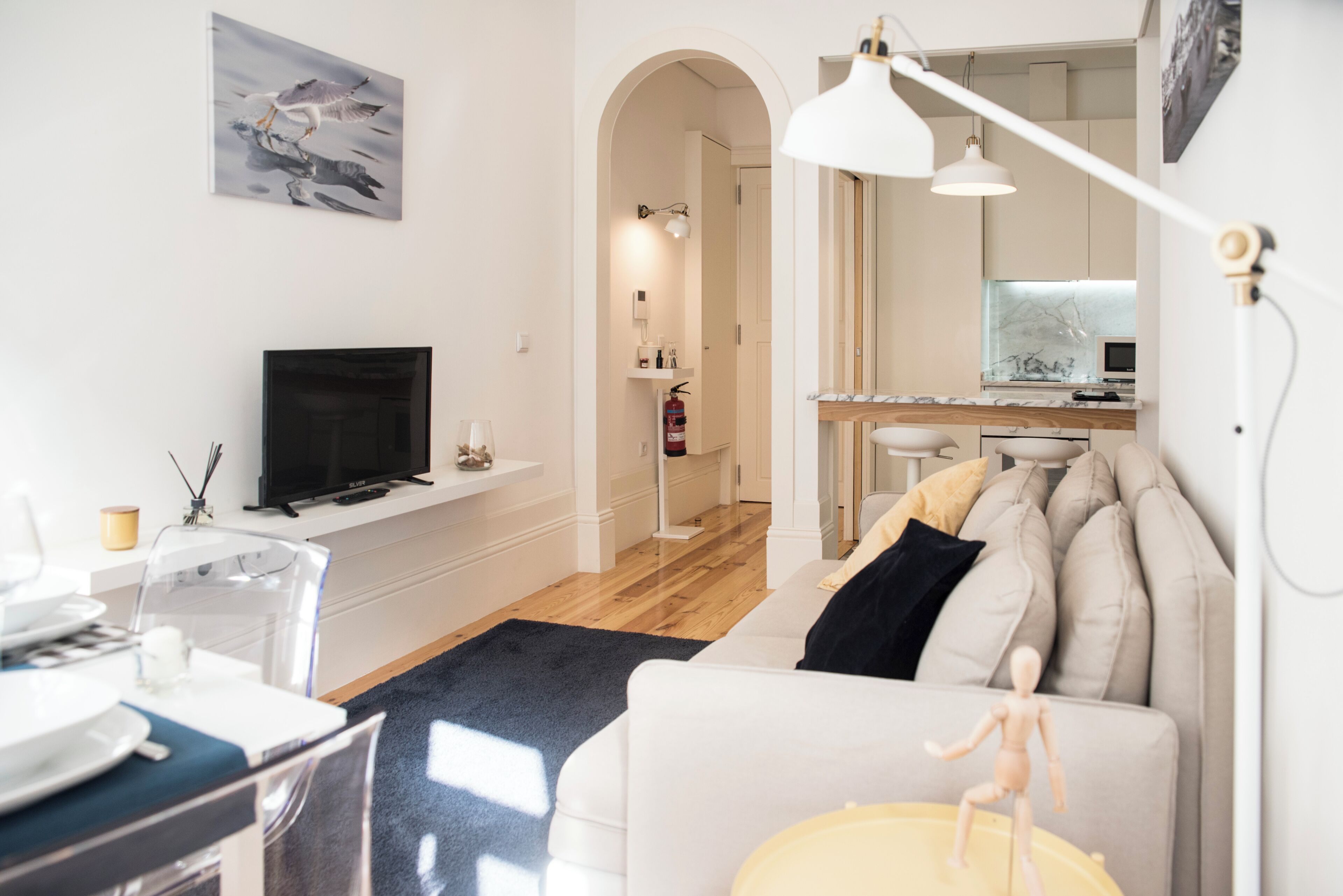 Un salon moderne avec un téléviseur, un canapé et un coin repas.