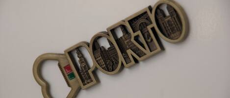 A keychain with the word 'PORGO' and a cityscape design.