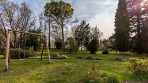 A park with a swing set, stone structures, and various trees. - XV century villa recently restored , located on Colà di Lazise (Colà di Lazise)