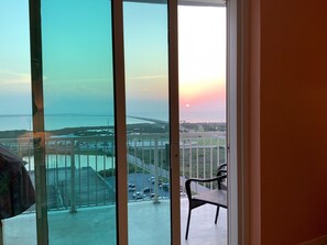 Enjoy breathtaking views of the coastal landscape from this balcony, featuring a bridge and a body of water.