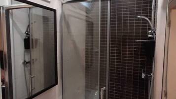 Shower, hair dryer, towels, toilet paper